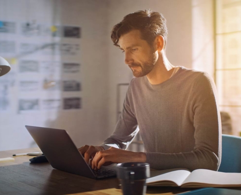 man using brain health supplements to work on his laptop and stay focused