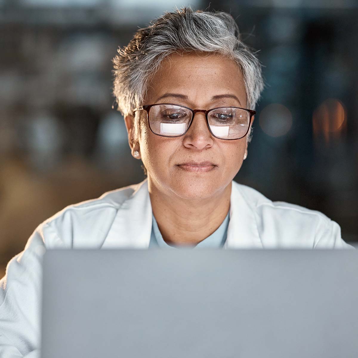 woman focusing on her laptop