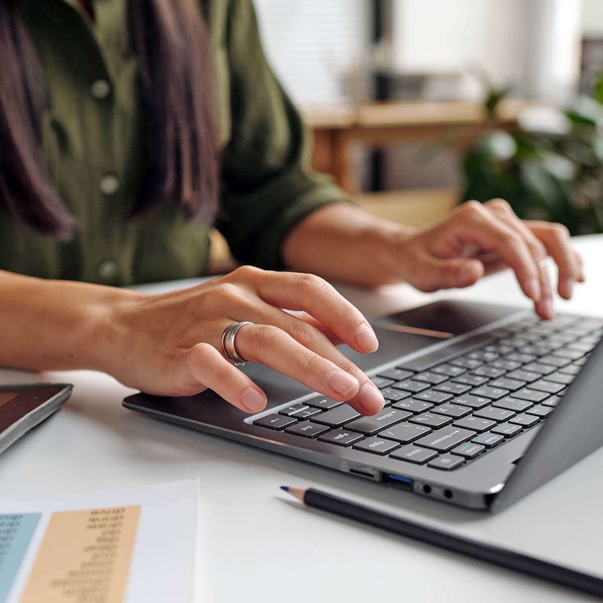 hands typing on a laptop