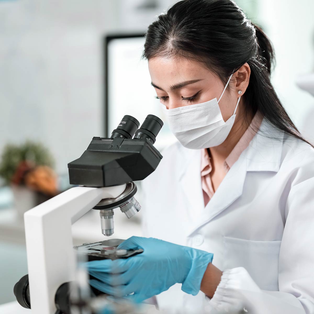 Formulation expert looking through a microscope