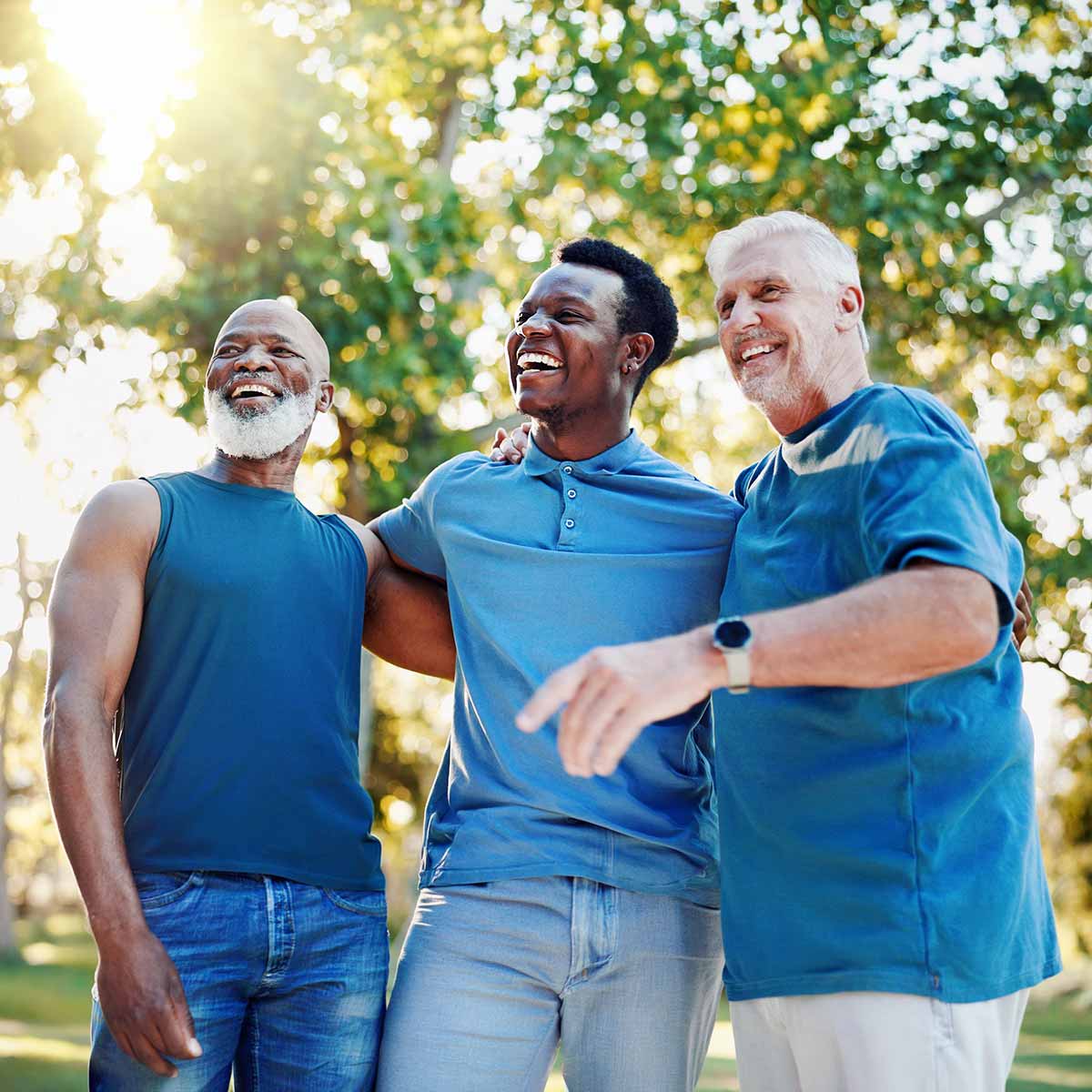 a group of three men who are friends hanging out together outdoors
