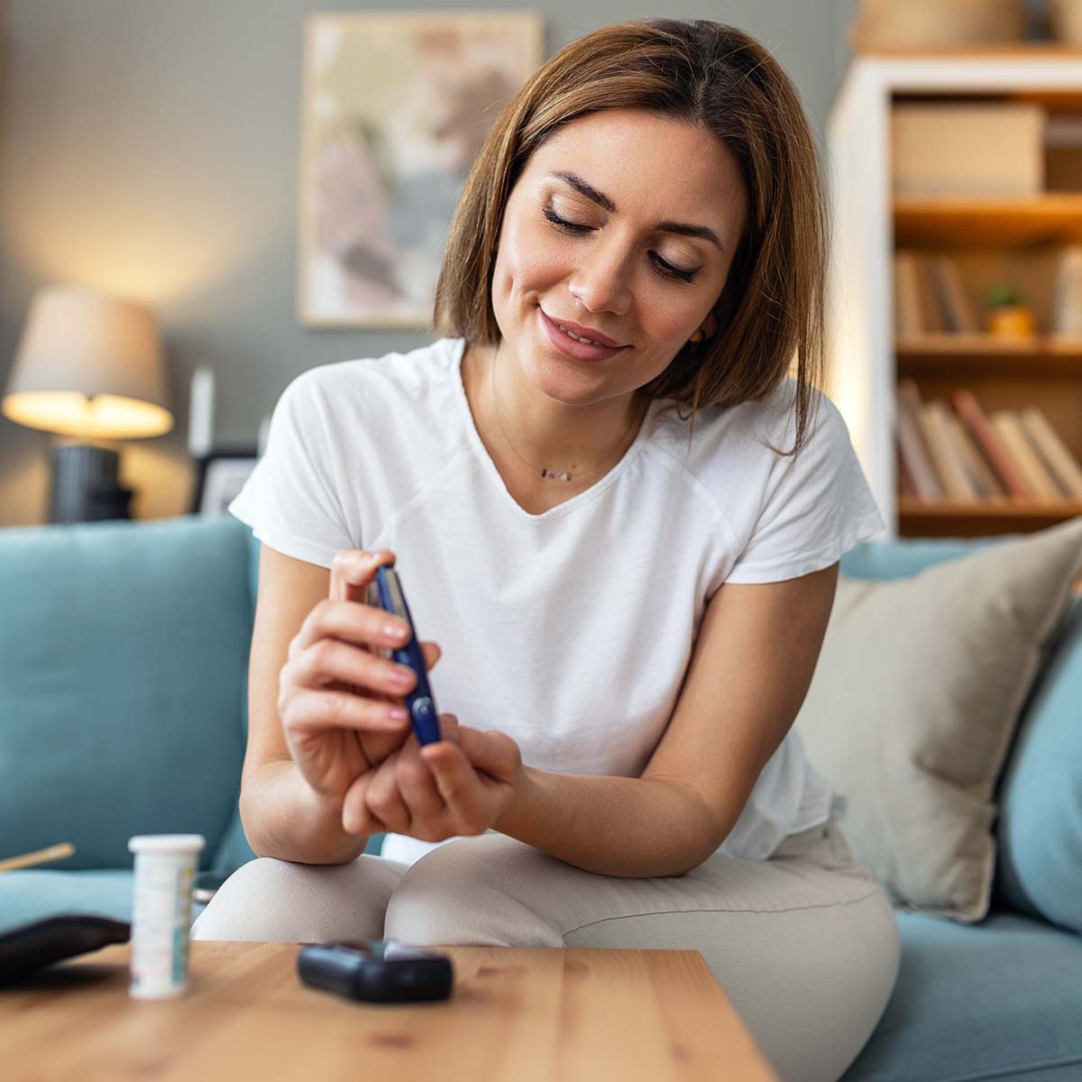diabetic woman checking blood glucose levels with a glucometer