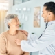 doctor listening to an elderly woman's heart through a stethoscope