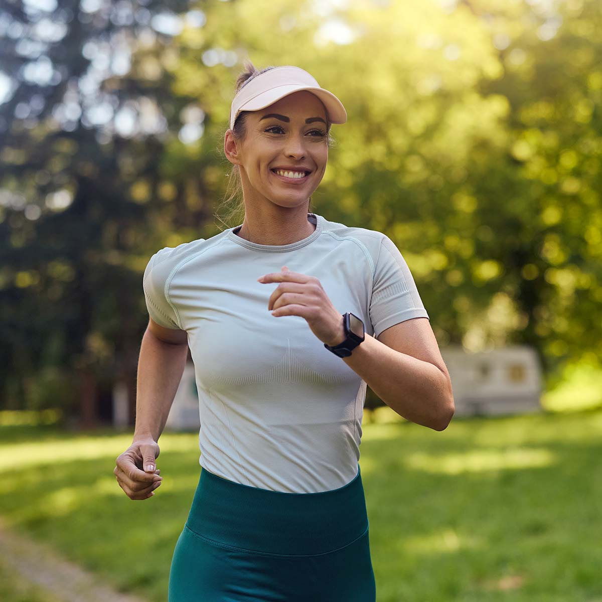 happy woman jogging in the park on a sunny day