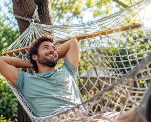 man relaxing in a hammock during the summer